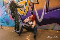 Mistress sat smoking in front of graffiti